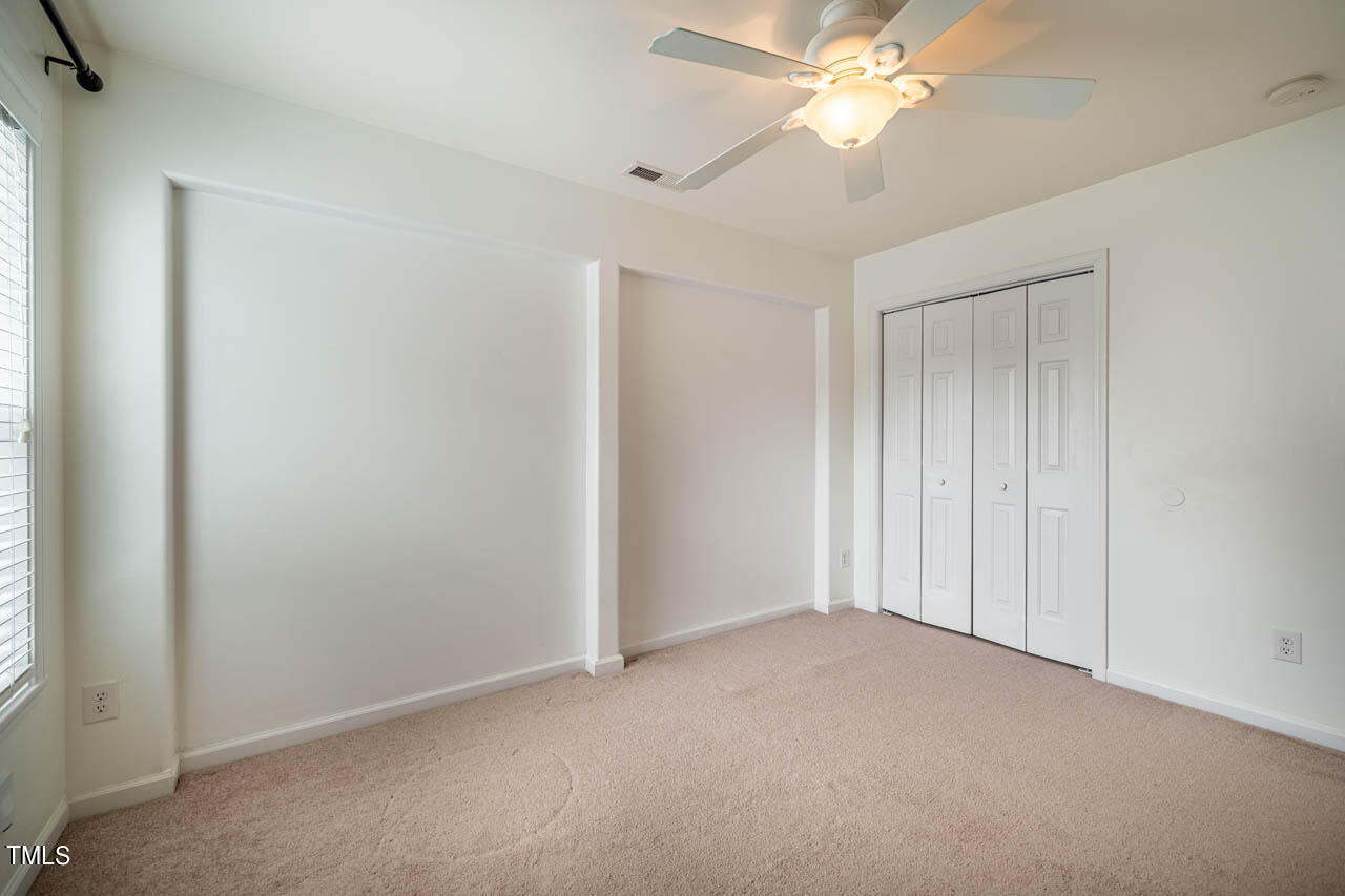 1314 Mallory Lane Durham, NC 27713 - Photo 40 of 47 an empty room with closet and a chandelier fan