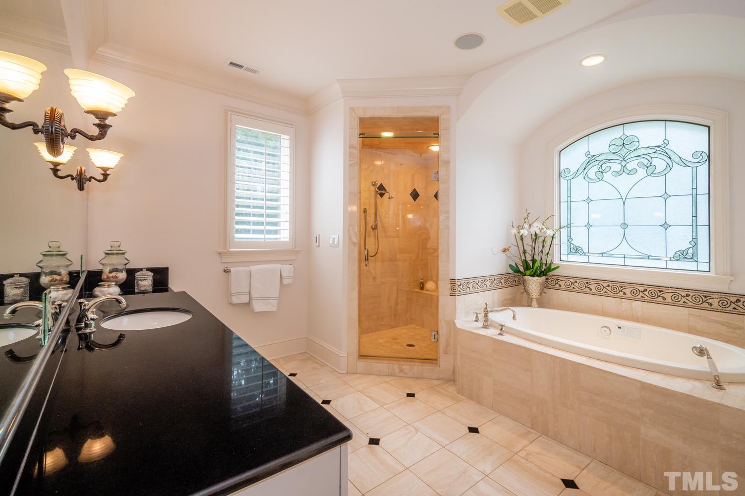 7128 Trenton Ridge Court, Unit 26 Raleigh, NC 27613 - Photo 21 of 30 a spacious bathroom with a tub sink and mirror