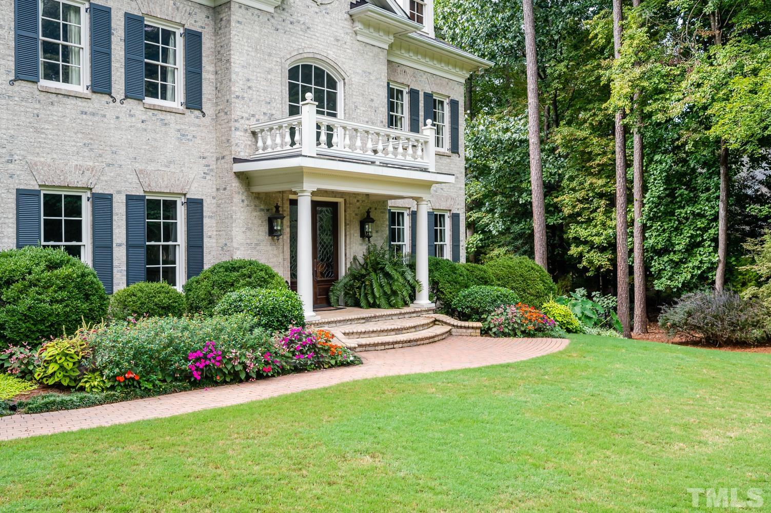 7128 Trenton Ridge Court, Unit 26 Raleigh, NC 27613 - Photo 5 of 30 a front view of a house with porch and garden