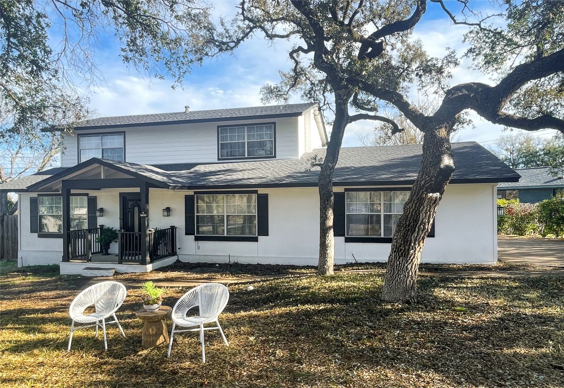 a front view of a house with garden and porch