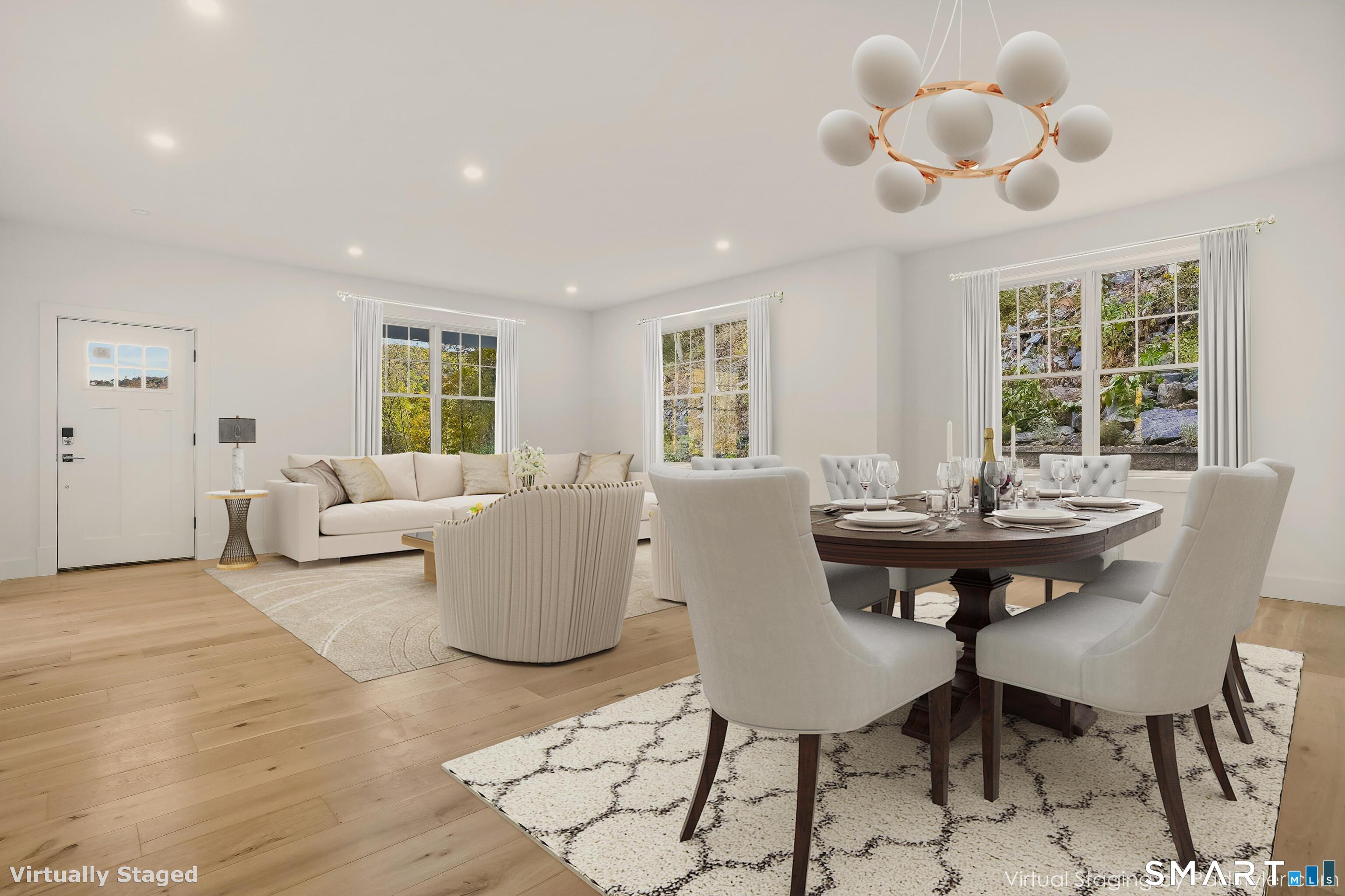 309 South Britain Road Southbury, CT 06488 - Photo 3 of 25 Abundant natural light in the living room/dining room with engineered wood flooring throughout the home.