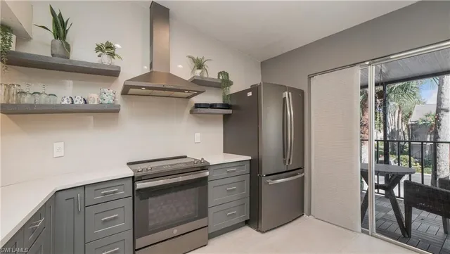 a kitchen with stainless steel appliances a refrigerator and a stove