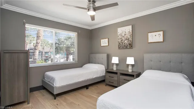 a bedroom with two beds and a window