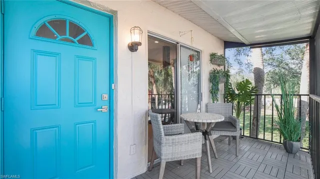 a view of a balcony with furniture and wooden floor