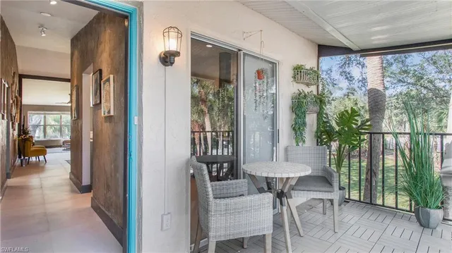 a view of a balcony with furniture and a table