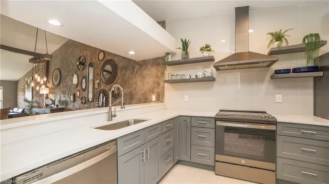 a kitchen with stainless steel appliances granite countertop a sink and cabinets