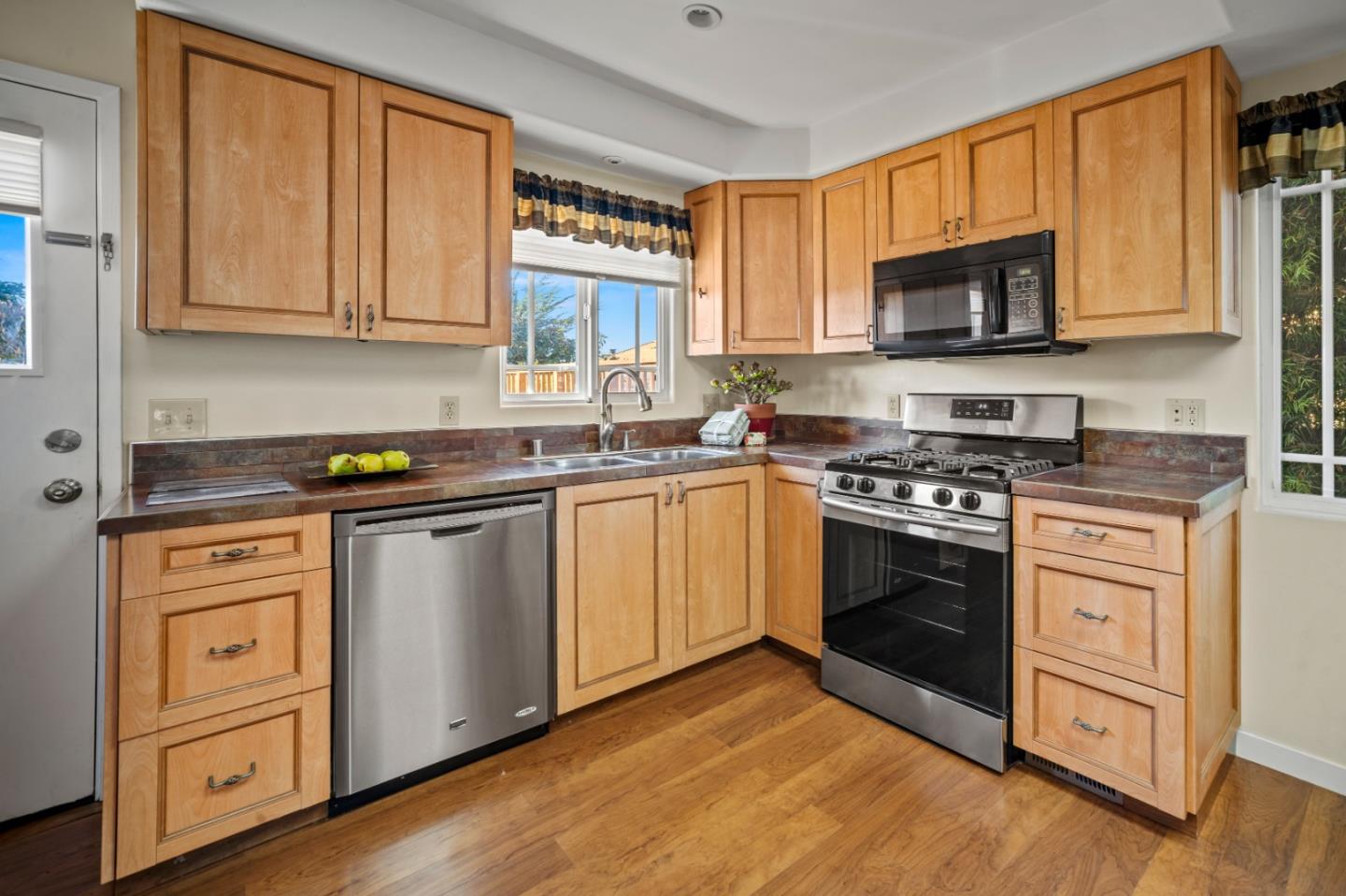 1717 Harding Street Seaside, CA 93955 - Photo 11 of 28 a kitchen with stainless steel appliances granite countertop a stove a sink and a microwave