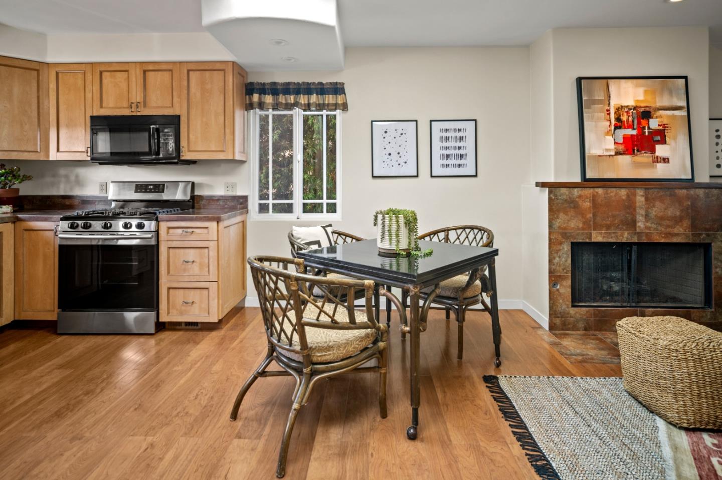 1717 Harding Street Seaside, CA 93955 - Photo 6 of 28 a kitchen with stainless steel appliances granite countertop a stove a refrigerator a kitchen island a dining table and chairs with wooden floor