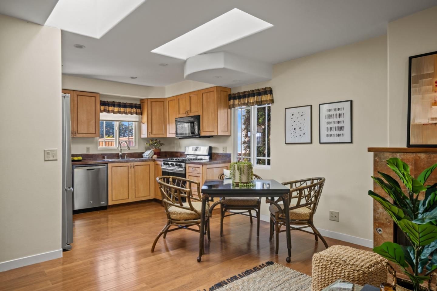 1717 Harding Street Seaside, CA 93955 - Photo 8 of 28 a kitchen with a table chairs refrigerator and cabinets