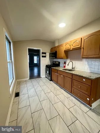 a kitchen with stainless steel appliances granite countertop a sink stove and cabinets