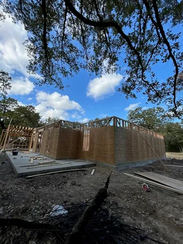 a front view of house with a garden