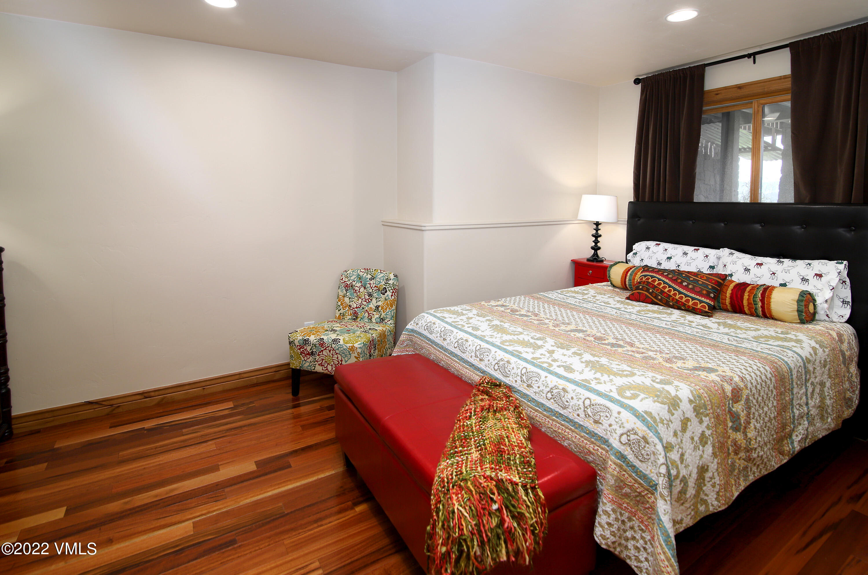 4530 Flat Point, Unit A Avon, CO 81620 - Photo 15 of 22 a bedroom with a bed and a painting on the wall