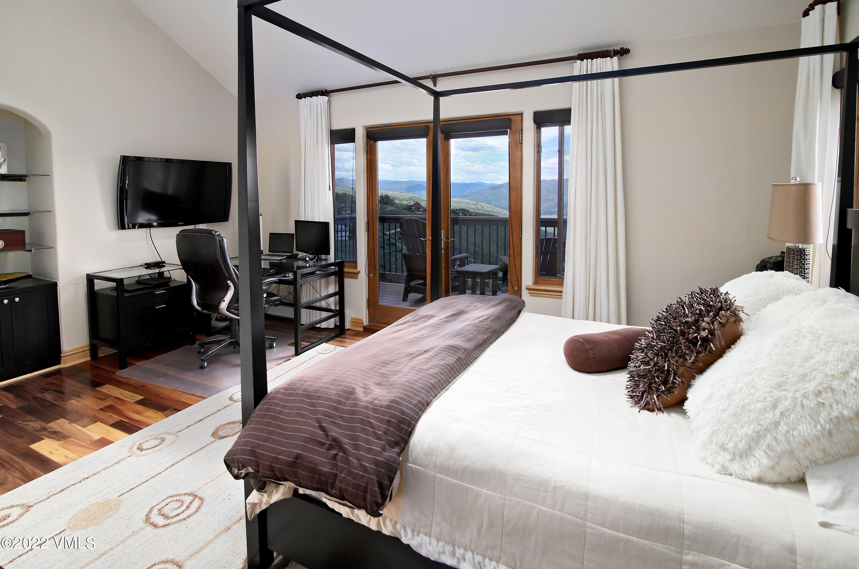 4530 Flat Point, Unit A Avon, CO 81620 - Photo 9 of 22 a bedroom with a bed and a flat tv screen on the dresser