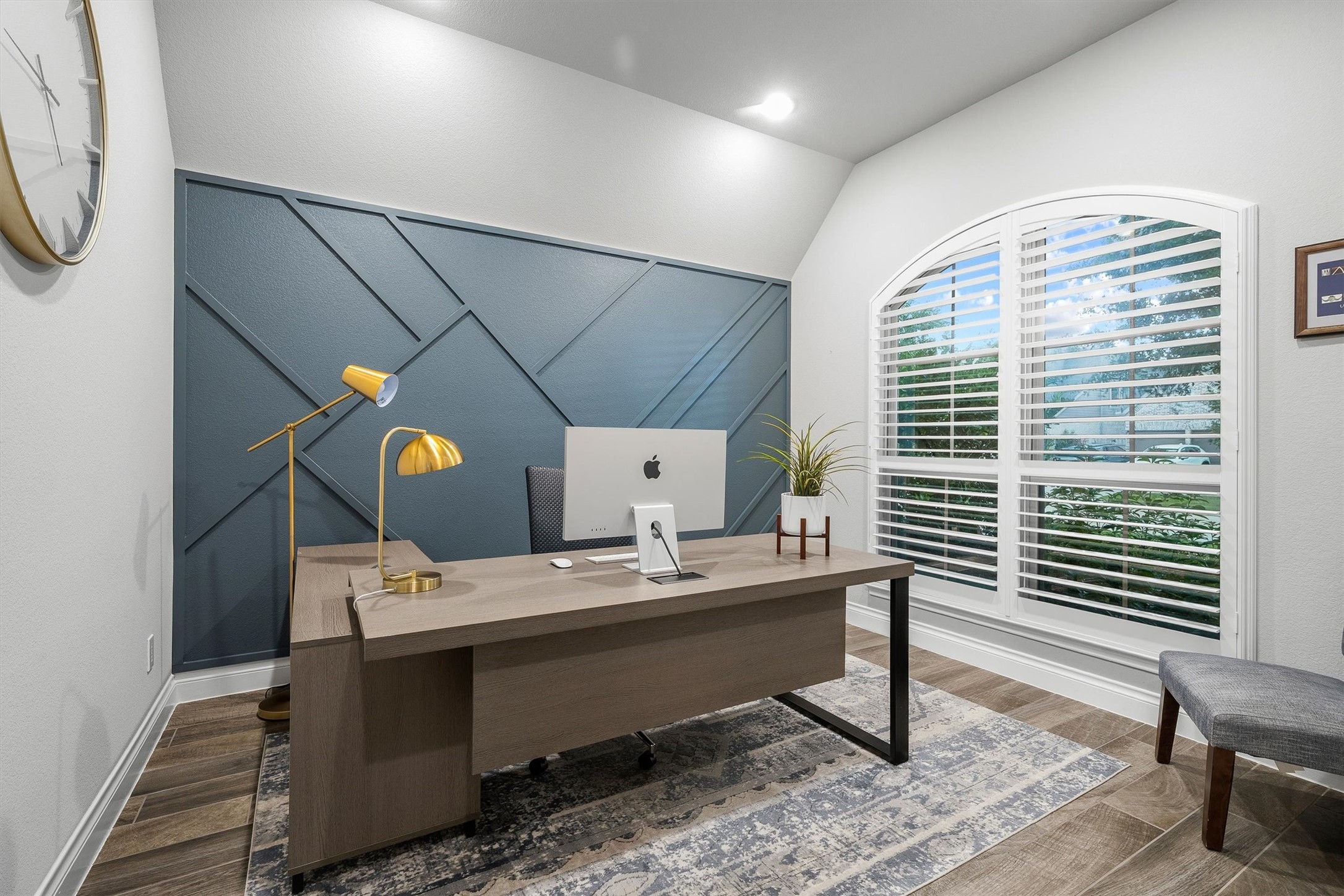 29118 Lantana Ridge Court Fulshear, TX 77441 - Photo 4 of 29 This beautifully designed home office showcases wood-look tile flooring, sun-filled windows with privacy blinds, and a custom accent wall, creating the perfect blend of style and functionality for working from home.