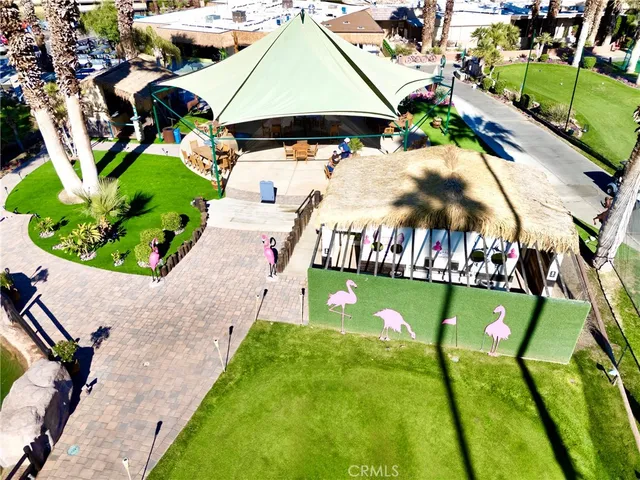 a view of a patio with table and chairs under an umbrella
