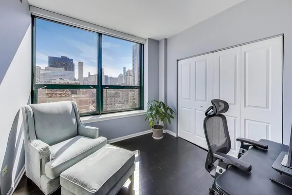 a living room with furniture a window and gym equipment