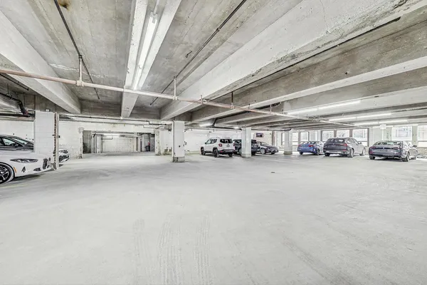 a view of parking garage with cars