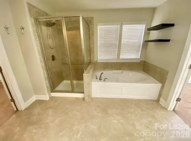 a bathroom with a bathtub and a shower