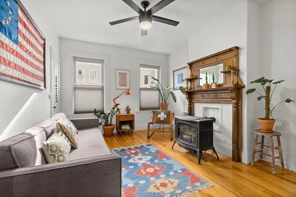 a living room with furniture a fireplace and a flat screen tv
