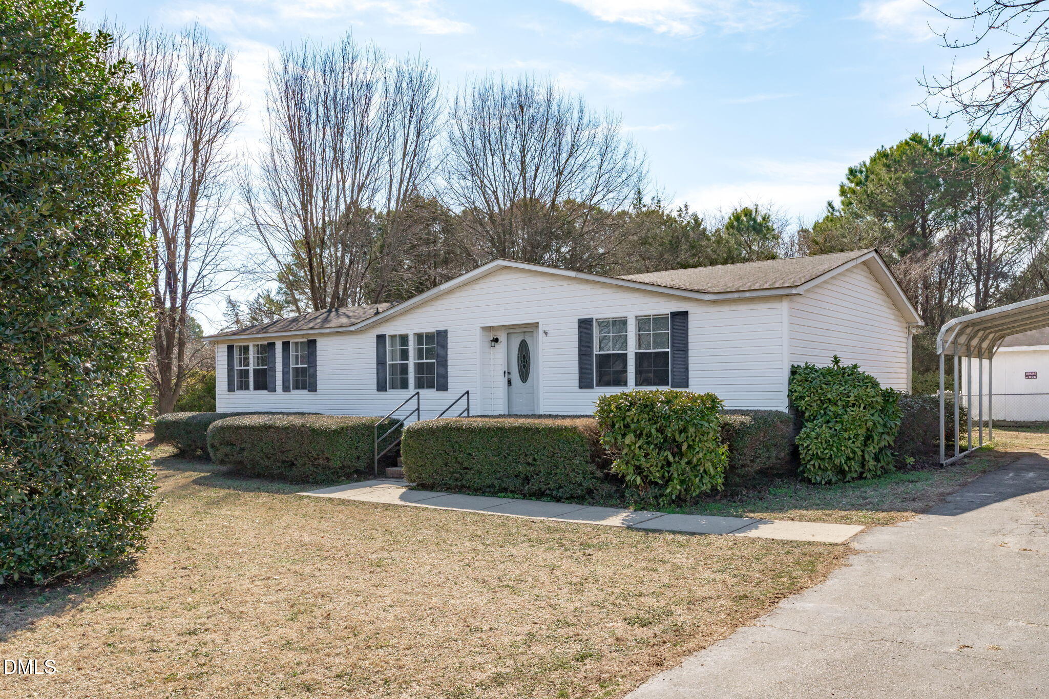 7900 Barbour Store Road Willow Spring, NC 27592 - Photo 1 of 38 a front view of a house with garden