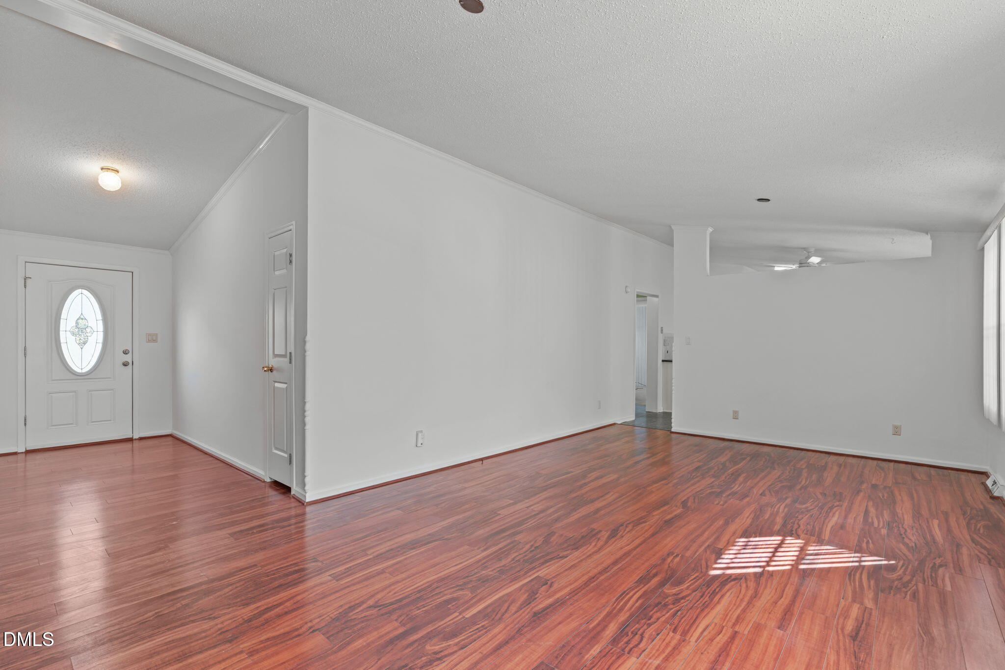 7900 Barbour Store Road Willow Spring, NC 27592 - Photo 3 of 38 a view of an empty room with wooden floor and window