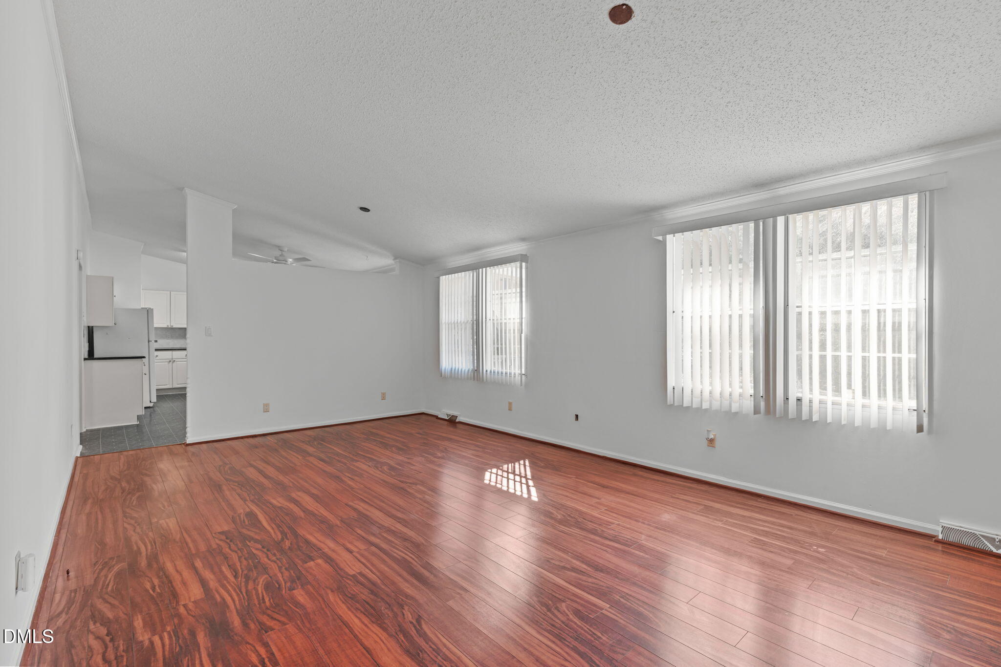7900 Barbour Store Road Willow Spring, NC 27592 - Photo 6 of 38 a view of an empty room with wooden floor and a window
