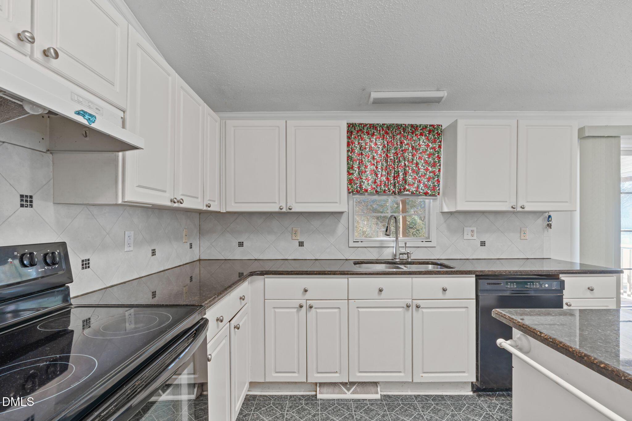 7900 Barbour Store Road Willow Spring, NC 27592 - Photo 9 of 38 a kitchen with granite countertop a sink cabinets and stainless steel appliances