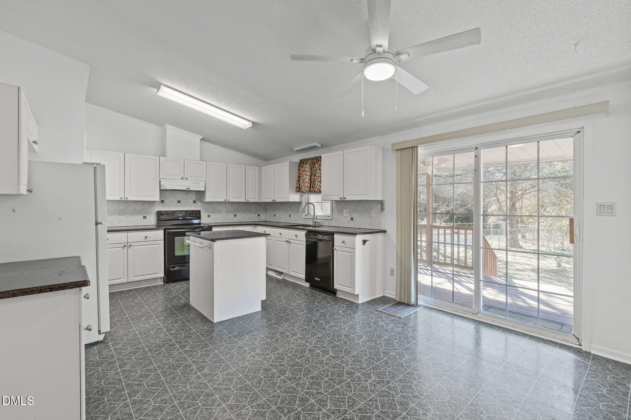 7900 Barbour Store Road Willow Spring, NC 27592 - Photo 10 of 38 a kitchen with a stove a sink and a refrigerator