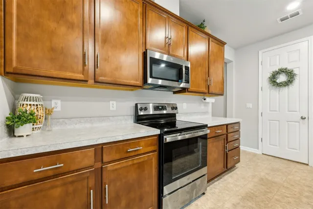 a kitchen with a sink stainless steel appliances and counter space