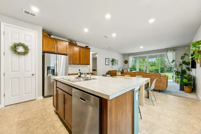 a kitchen with stainless steel appliances granite countertop a sink a stove and microwave