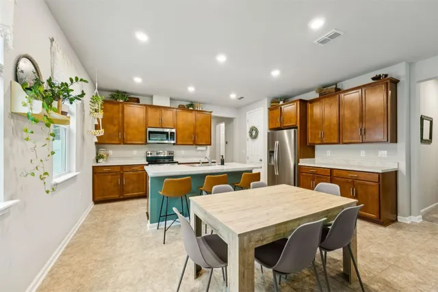a kitchen with stainless steel appliances granite countertop a sink and a stove