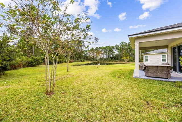 a view of a swimming pool with a yard
