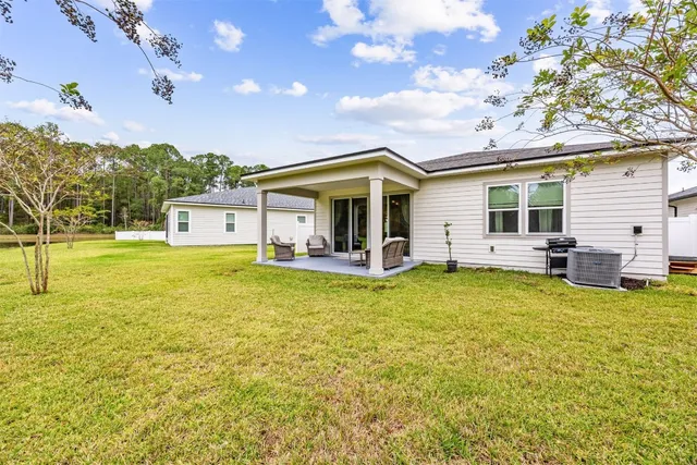 a view of a swimming pool with an outdoor space and seating area