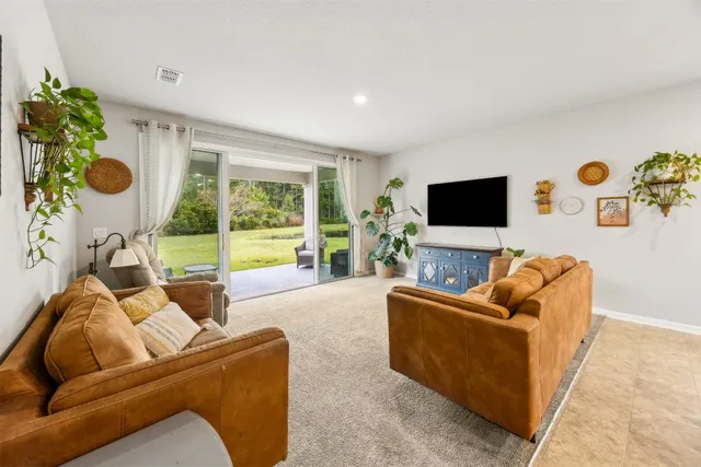 a kitchen with stainless steel appliances granite countertop a sink a stove a refrigerator cabinets and chairs