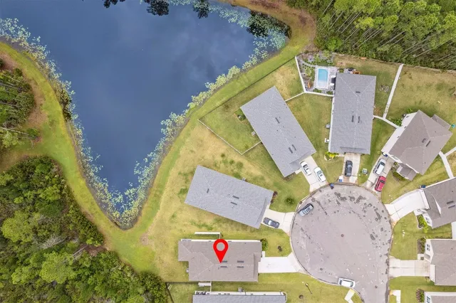 a aerial view of a house next to a yard