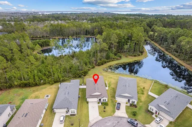 an aerial view of residential house with outdoor space and parking