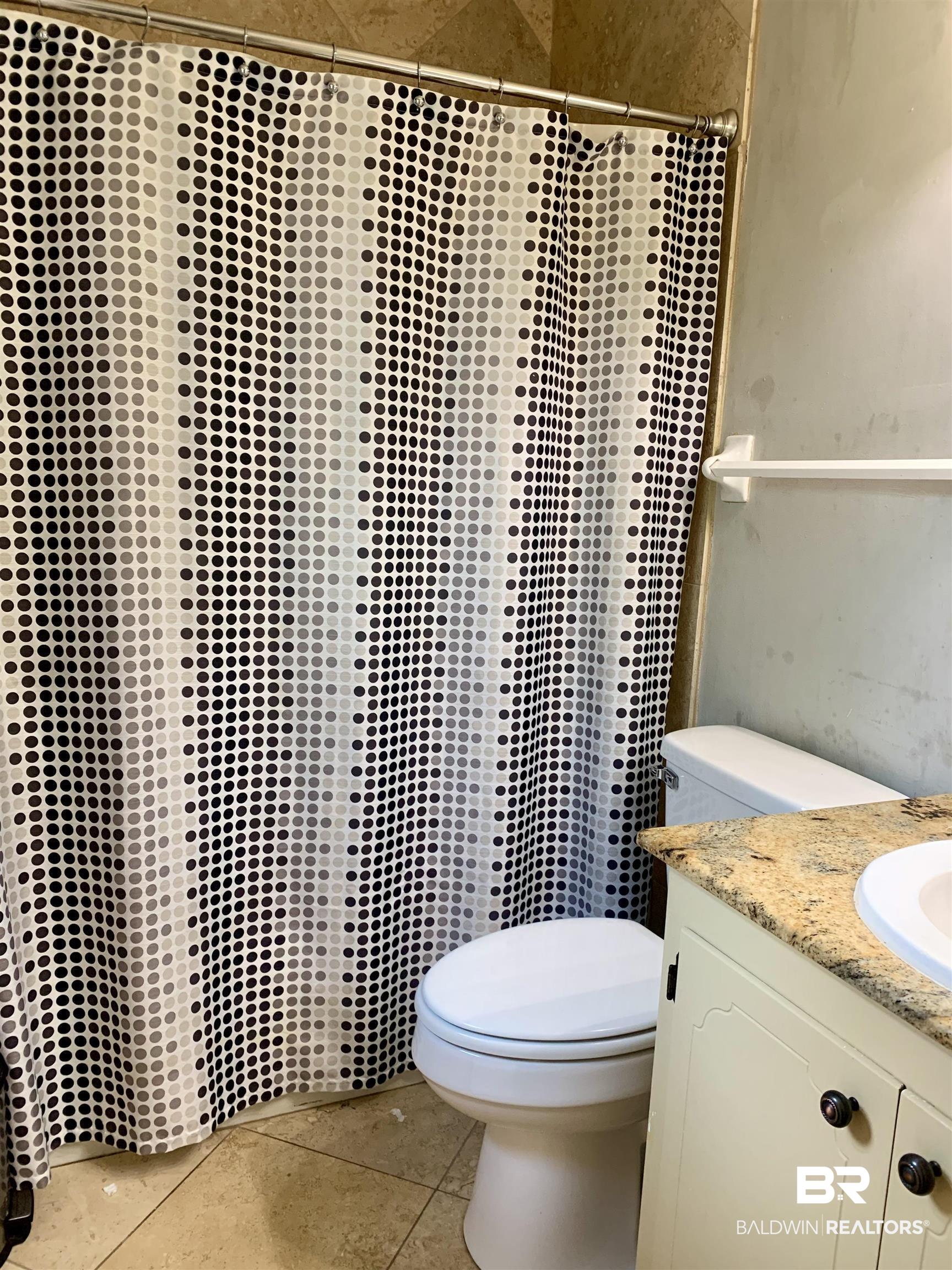 2708 E Road Mobile, AL 36693 - Photo 8 of 12 Bathroom featuring vanity, toilet, and tile patterned flooring