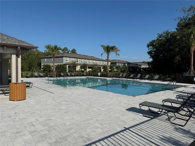 a view of swimming pool with outdoor seating and plants