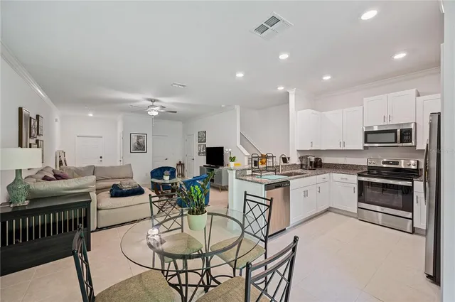 a kitchen with stainless steel appliances kitchen island granite countertop a sink and cabinets