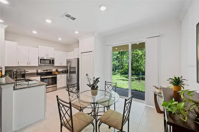 a kitchen with a table and chairs in it