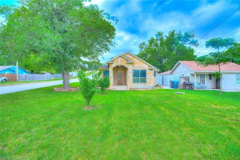 a view of house with yard and green space