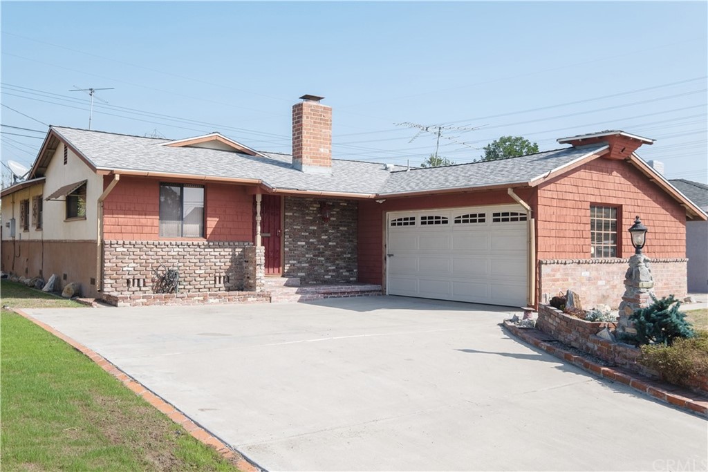 7119 Cortland Avenue Paramount, CA 90723 - Photo 1 of 30 a front view of a house with a yard