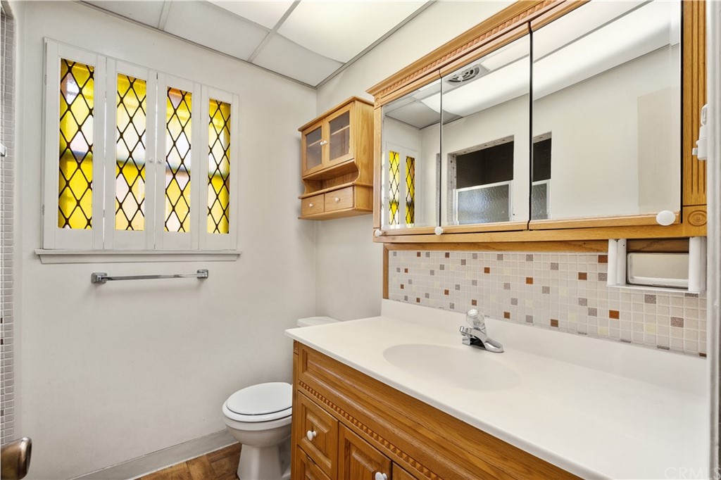 7119 Cortland Avenue Paramount, CA 90723 - Photo 17 of 30 a bathroom with a sink a toilet and a mirror