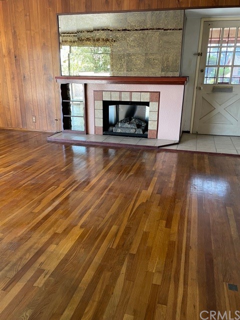 7119 Cortland Avenue Paramount, CA 90723 - Photo 6 of 30 a view of a livingroom with wooden floor and a fireplace