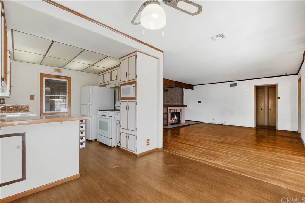 7119 Cortland Avenue Paramount, CA 90723 - Photo 10 of 30 a view of a kitchen with furniture and wooden floor
