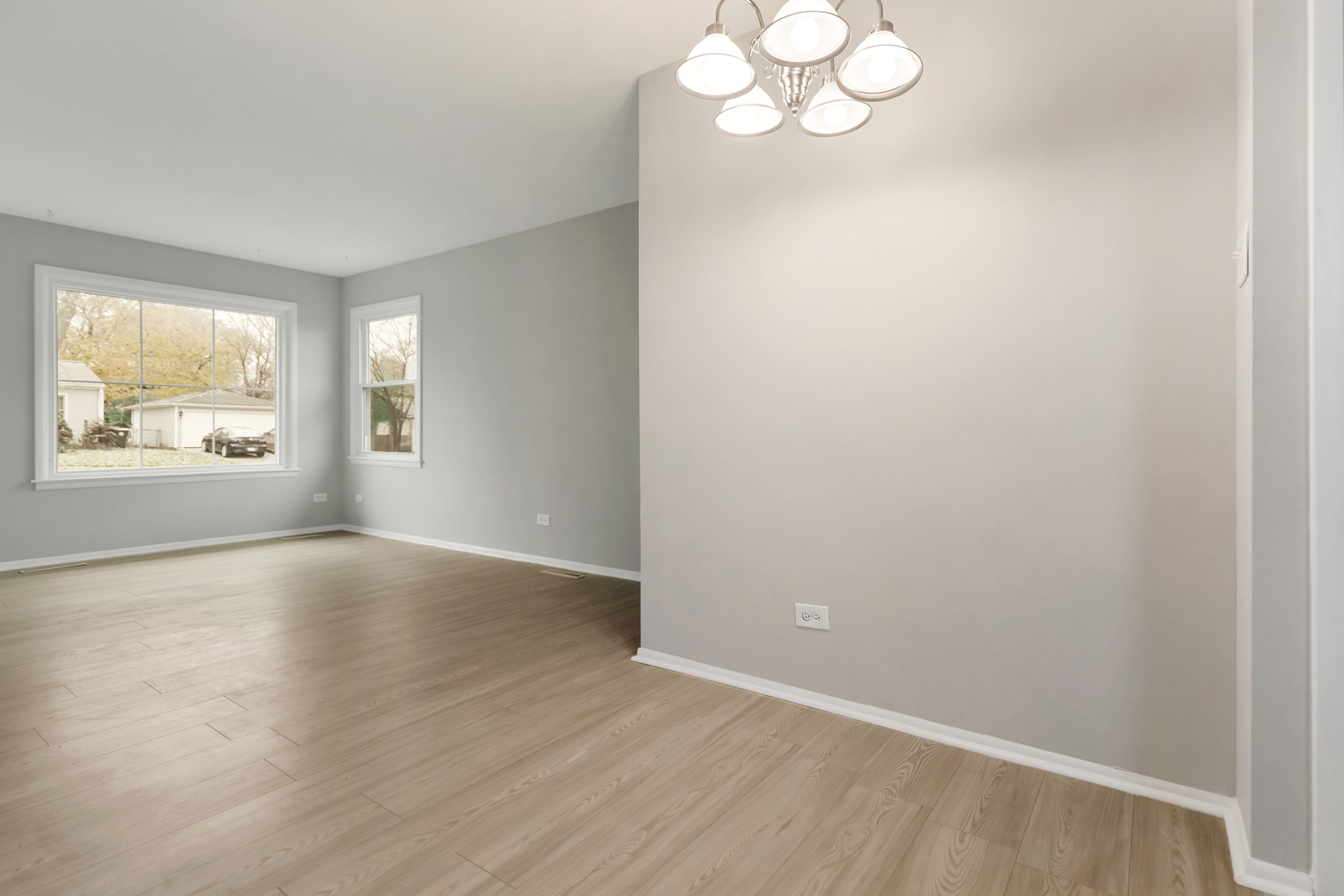 6971 Hanover Street Hanover Park, IL 60133 - Photo 6 of 20 an empty room with wooden floor and windows