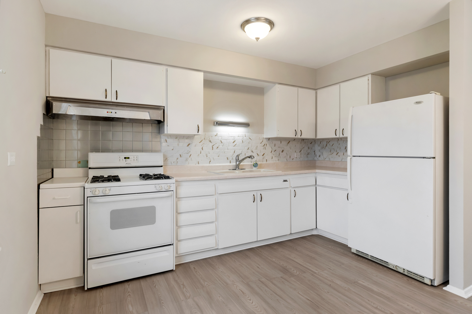 6971 Hanover Street Hanover Park, IL 60133 - Photo 7 of 20 a kitchen with cabinets appliances a sink and a stove