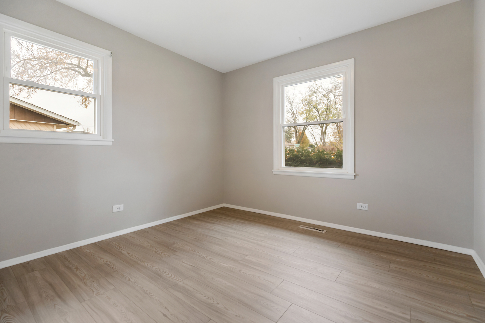 6971 Hanover Street Hanover Park, IL 60133 - Photo 8 of 20 a view of an empty room with wooden floor and a window