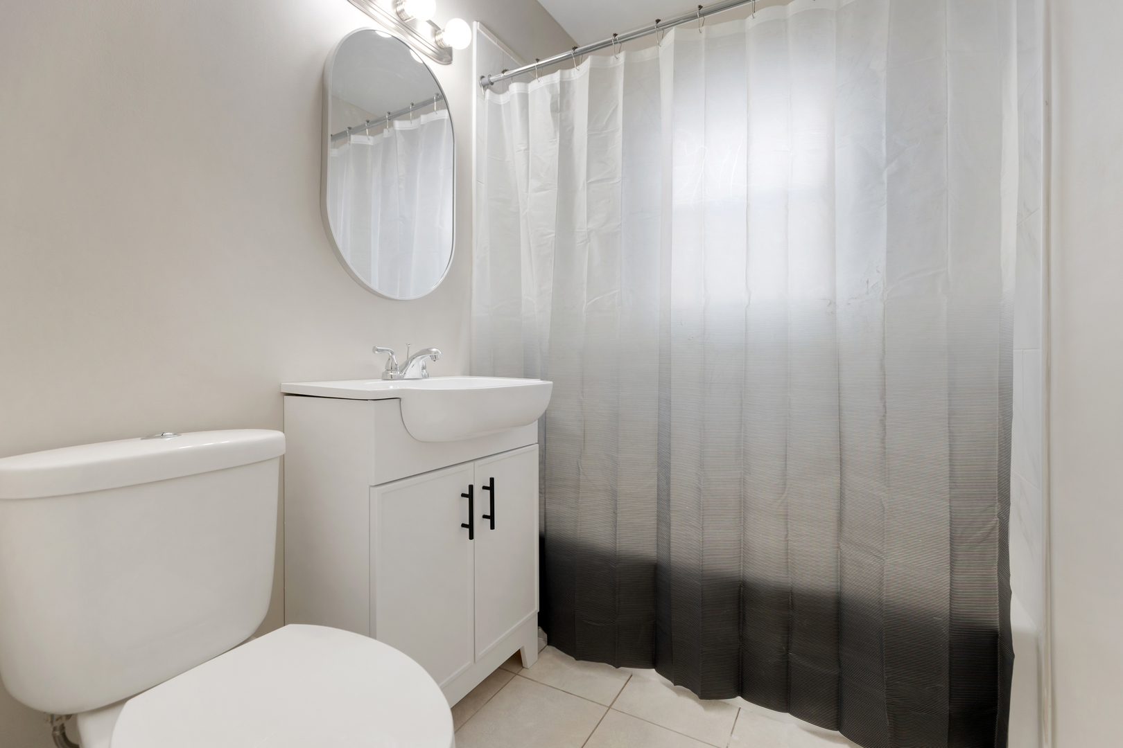 6971 Hanover Street Hanover Park, IL 60133 - Photo 9 of 20 a bathroom with a sink a toilet and shower curtain