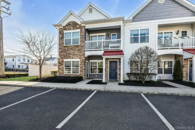 front view of a brick house with a yard